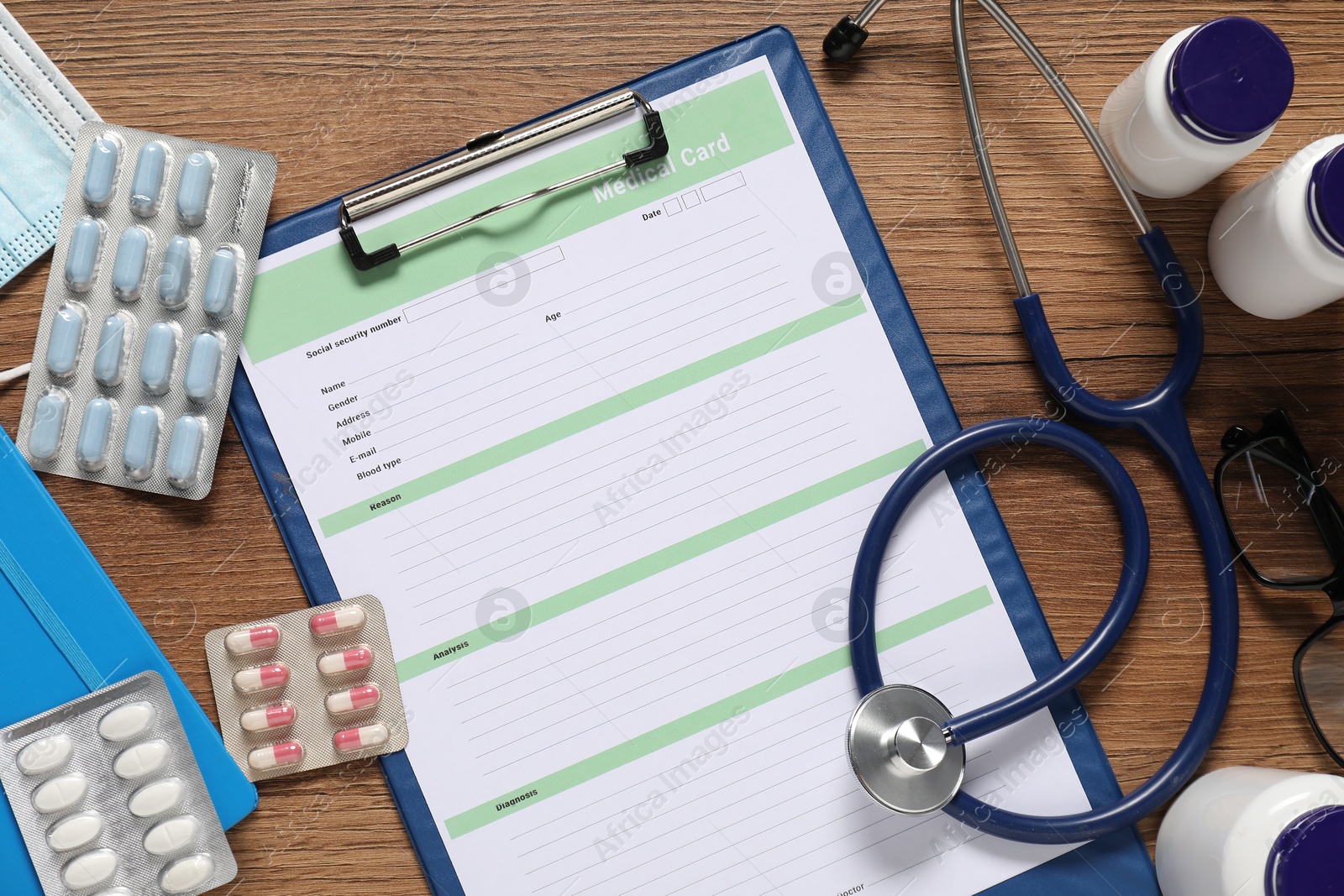 Photo of Flat lay composition with medical card form on wooden background