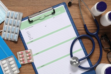 Photo of Flat lay composition with medical card form on wooden background