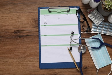 Flat lay composition with medical card form on wooden background