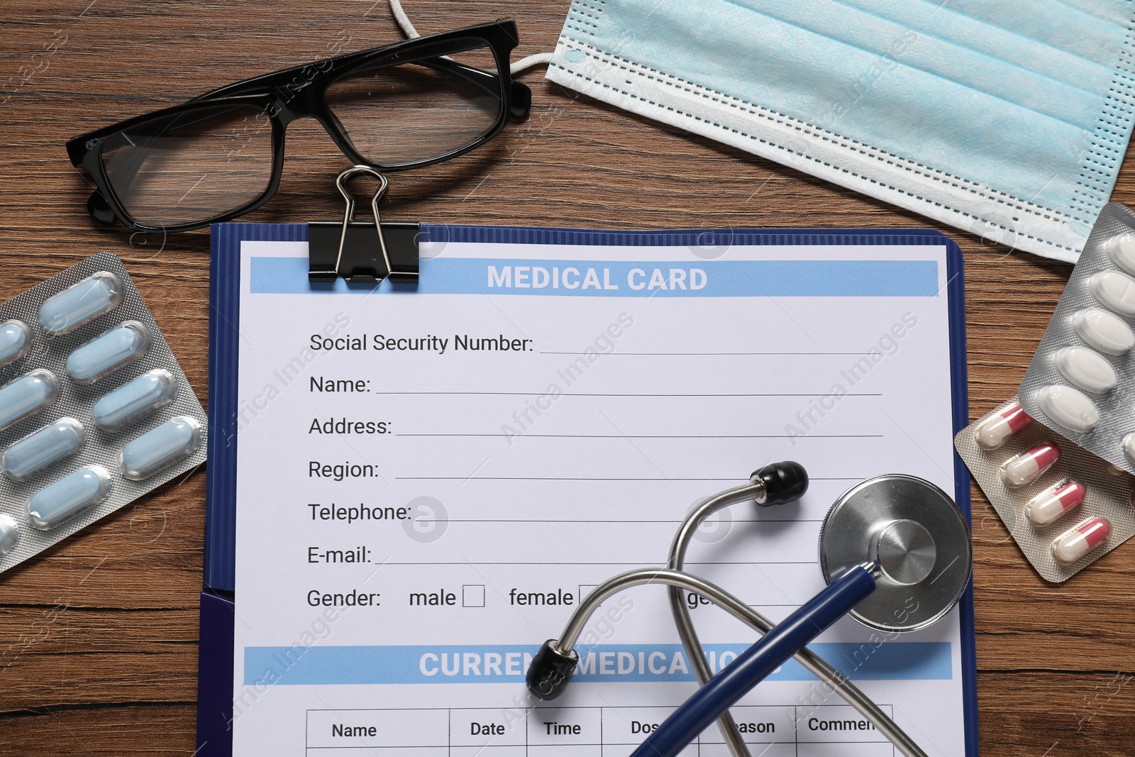 Photo of Flat lay composition with medical card form on wooden background