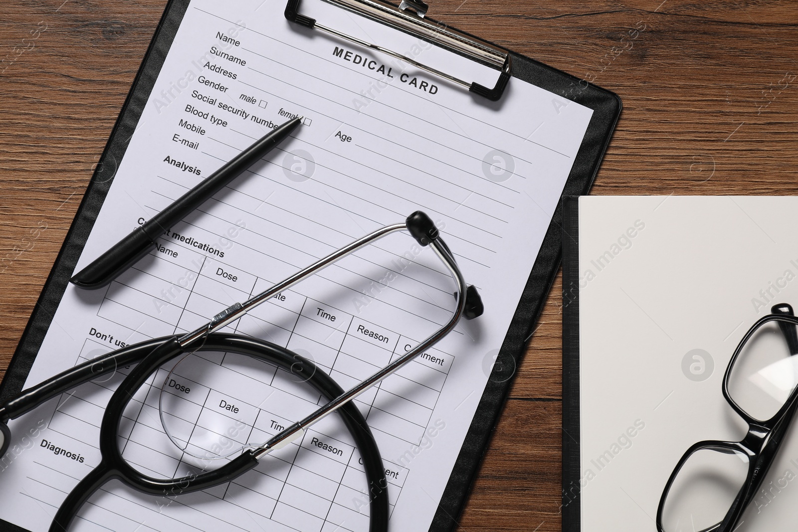 Photo of Flat lay composition with medical card form on wooden background