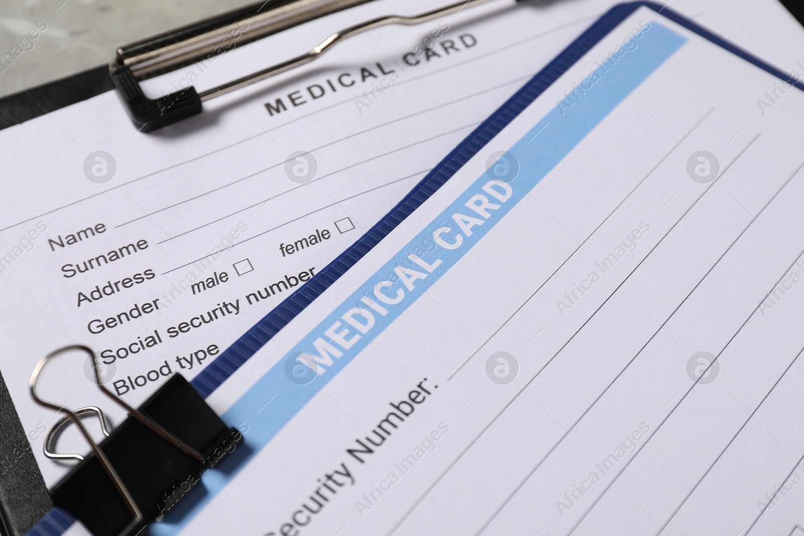 Photo of Medical card forms on grey background, closeup