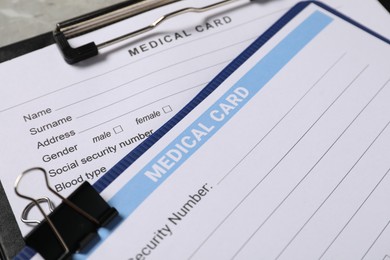 Medical card forms on grey background, closeup