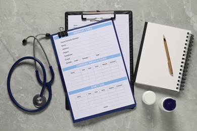 Photo of Flat lay composition with medical card form on grey background