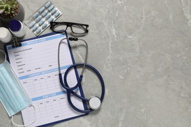 Photo of Flat lay composition with medical card form on grey background. Space for text