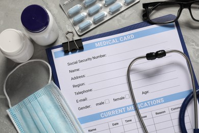 Photo of Flat lay composition with medical card form on grey background