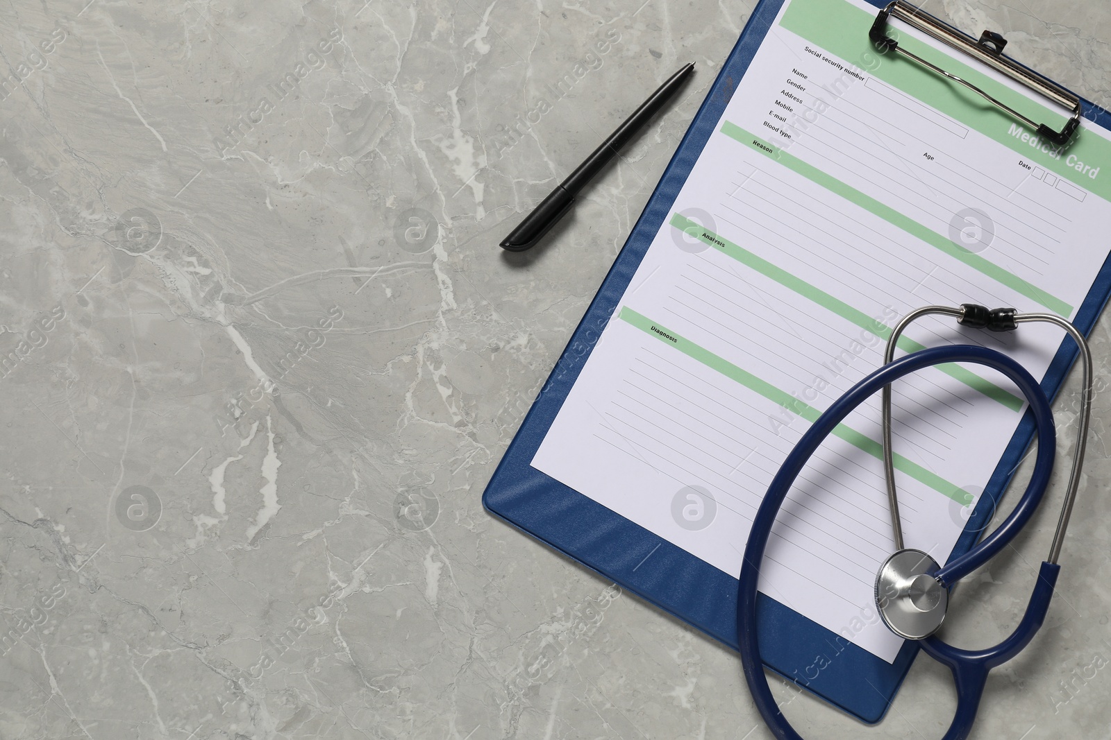 Photo of Medical card form, pen and stethoscope on grey background, top view. Space for text