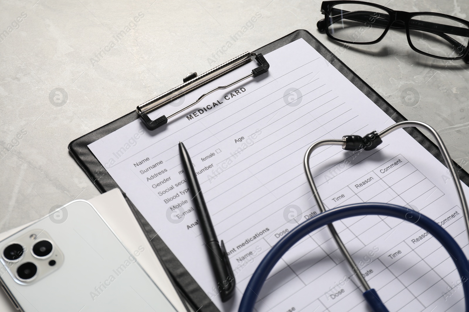 Photo of Composition with medical card form and pen on grey background, closeup