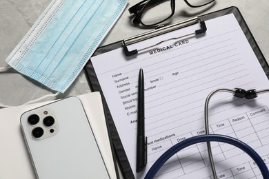 Photo of Composition with medical card form and pen on grey background, closeup