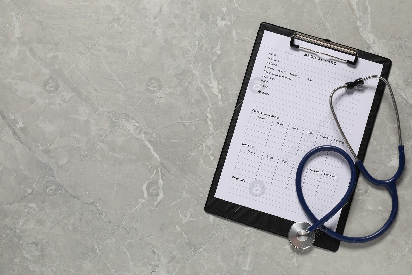 Photo of Medical card form and stethoscope on grey background, top view. Space for text