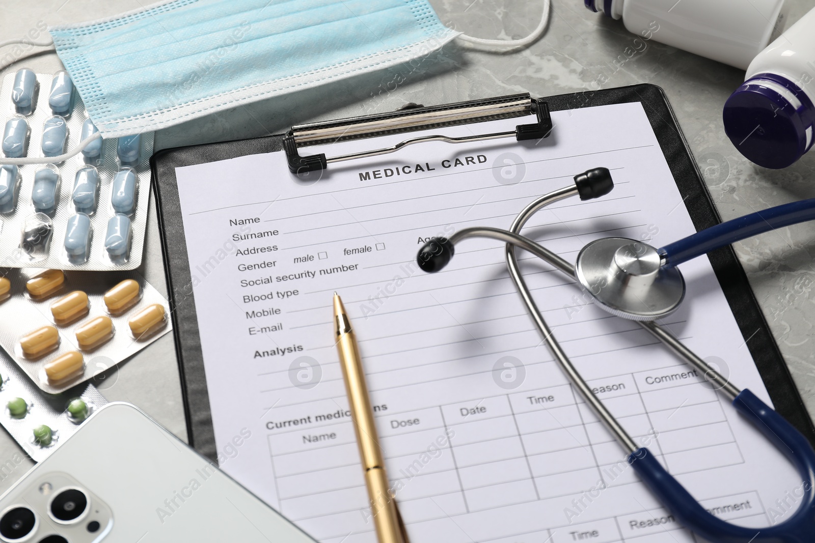 Photo of Composition with medical card form and pen on grey background, closeup