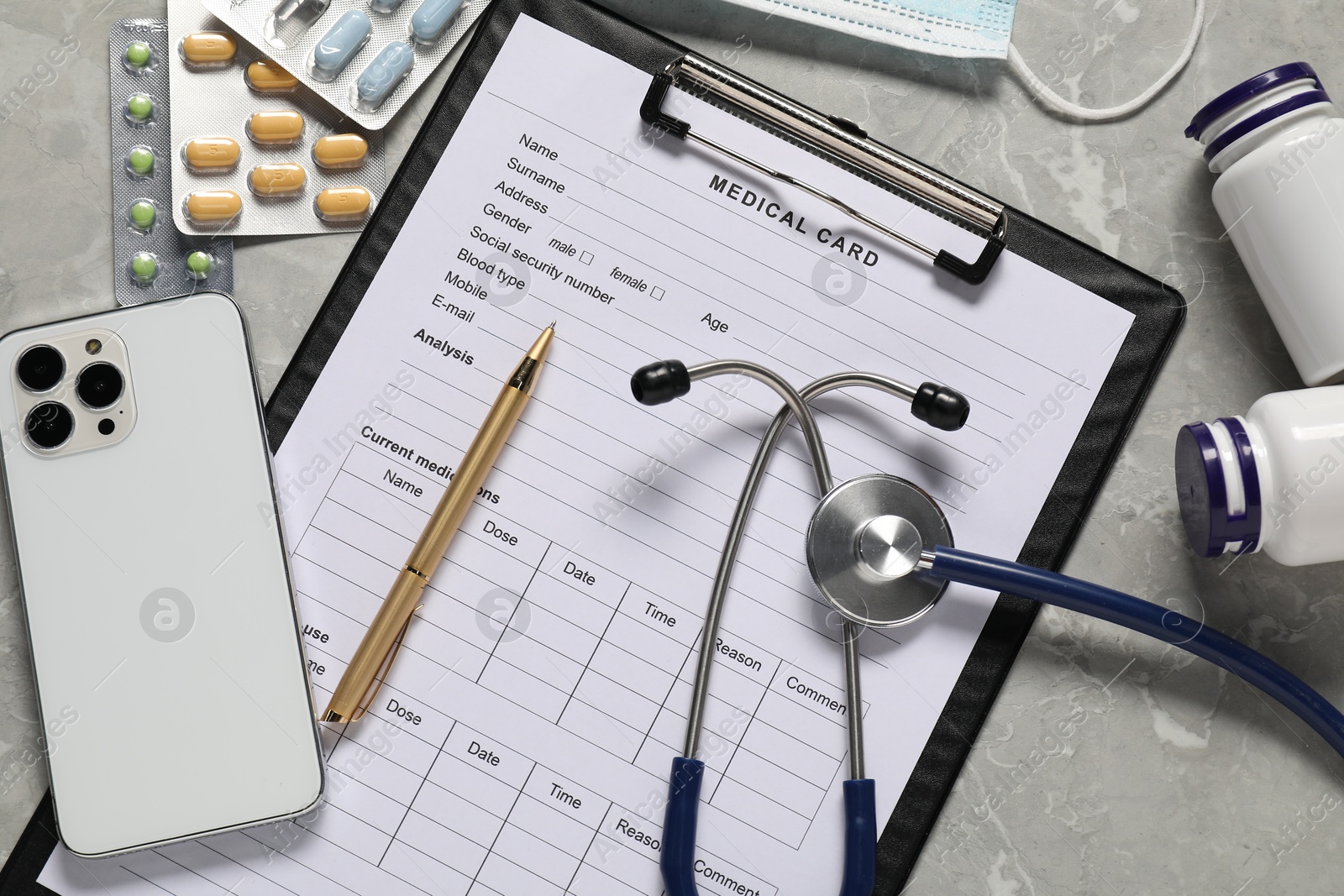 Photo of Flat lay composition with medical card form on grey background