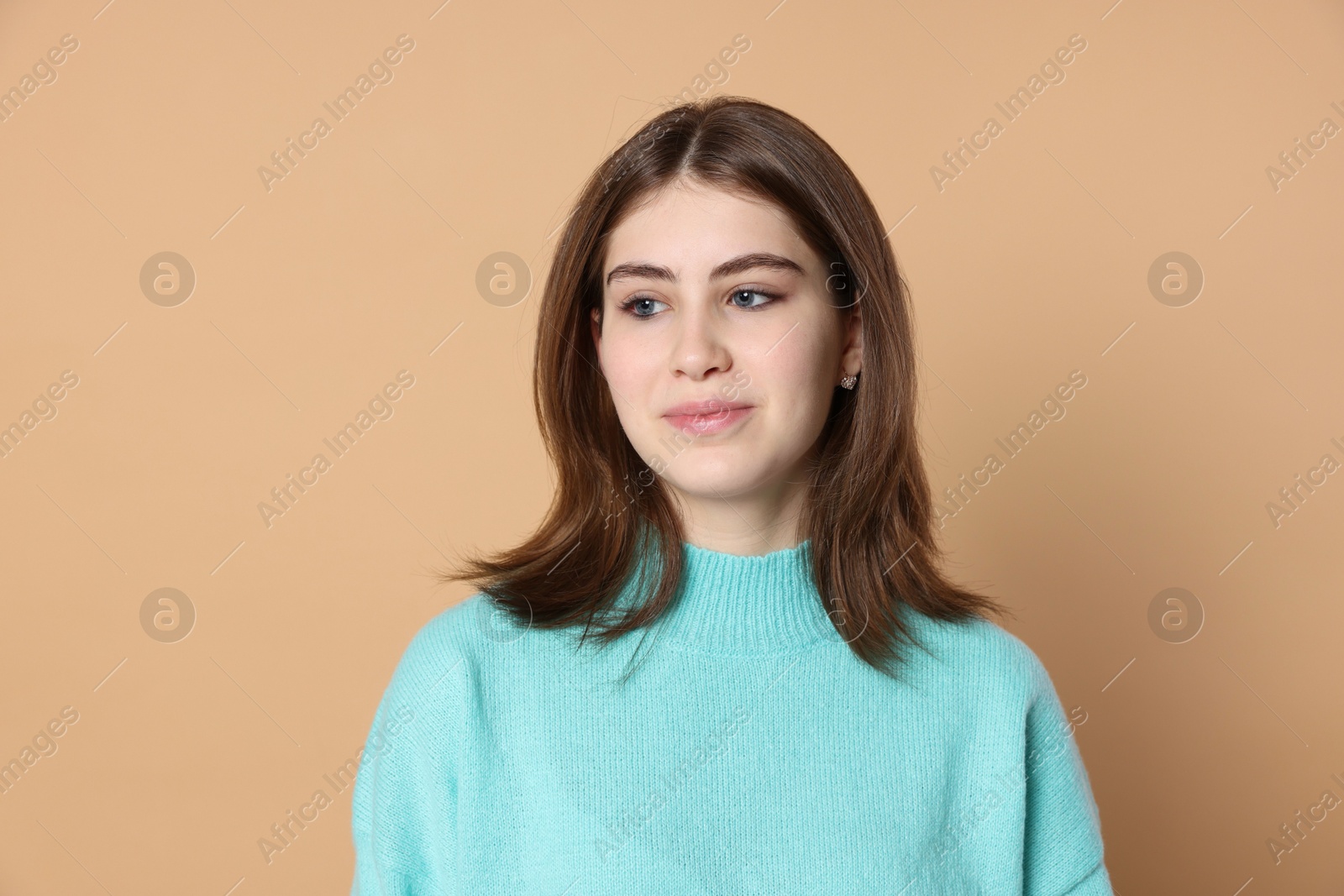 Photo of Portrait of beautiful teenage girl on beige background