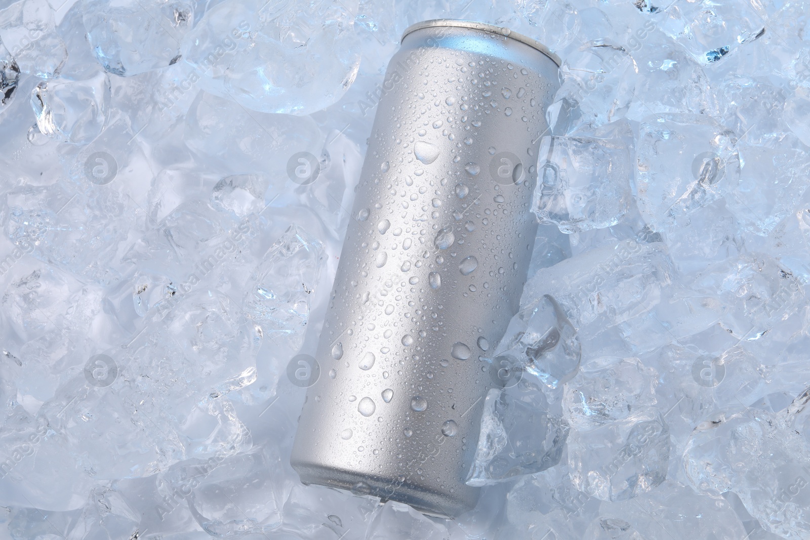 Refreshing drink in can on ice cubes, top view Photo of Refreshing drink in can on ice cubes, top view