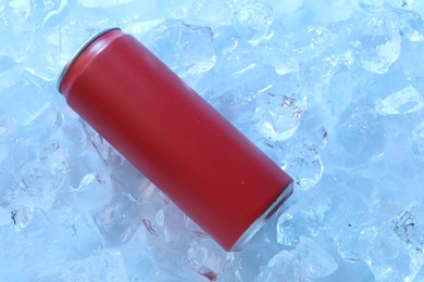 Photo of Refreshing drink in can on ice cubes, top view