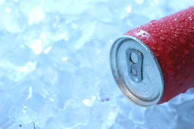 Photo of Refreshing drink in can on ice cubes, closeup. Space for text