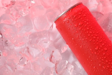 Photo of Refreshing drink in can on ice cubes, above view