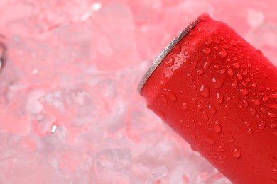 Photo of Refreshing drink in can on ice cubes, above view