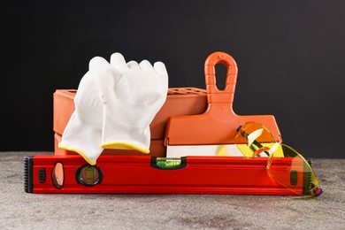 Different construction material and tools on grey table