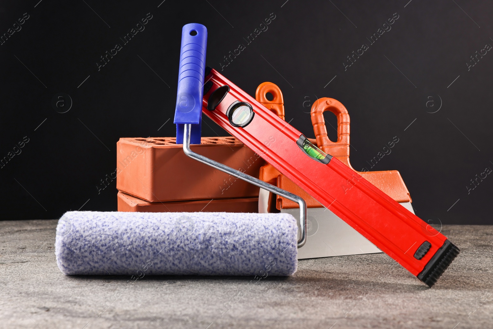 Photo of Different construction material and tools on grey table