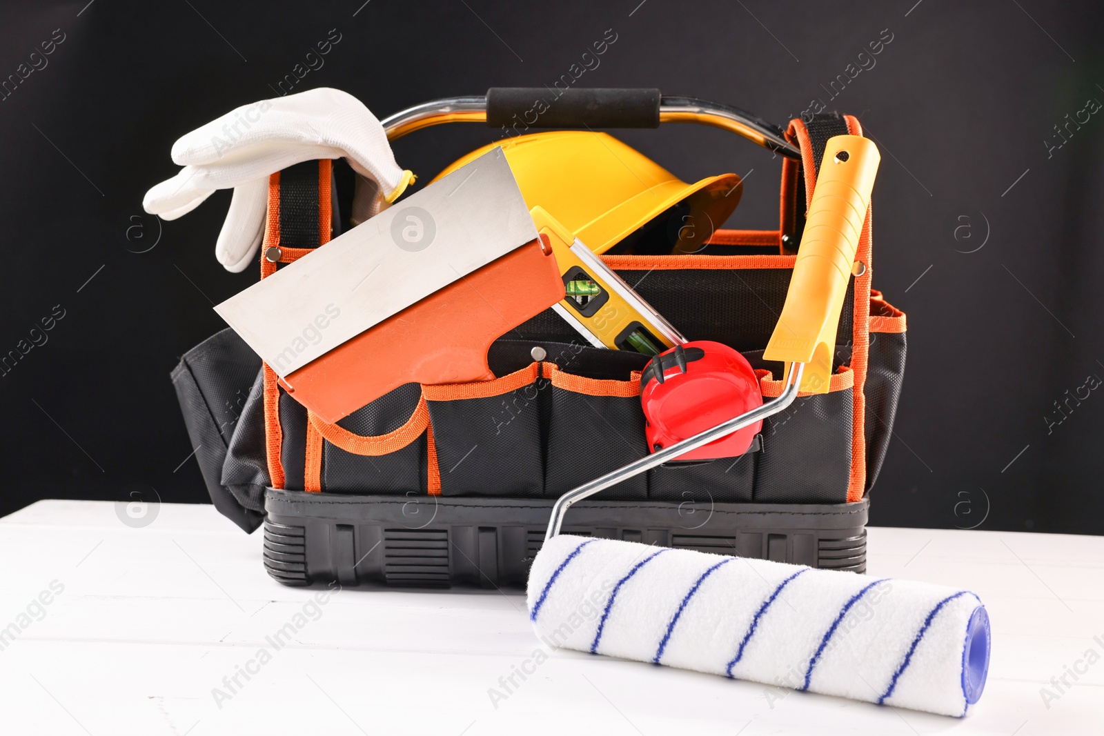 Photo of Different construction material and tools on white wooden table