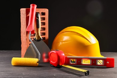 Photo of Different construction material and tools on black table