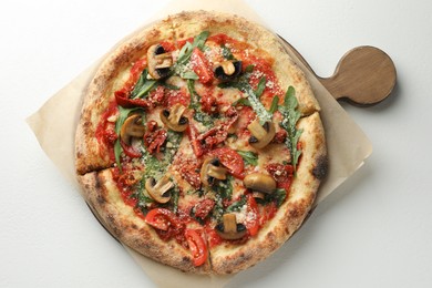 Tasty pizza with mushrooms, tomatoes and arugula on white table, top view