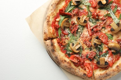 Photo of Tasty pizza with mushrooms, tomatoes and arugula on white table, top view. Space for text