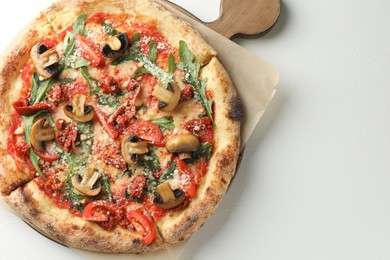 Photo of Tasty pizza with mushrooms, tomatoes and arugula on white table, top view. Space for text