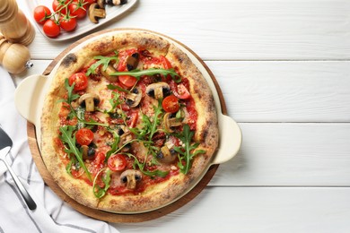 Tasty pizza with mushrooms, tomatoes, arugula and server on white wooden table, flat lay. Space for text