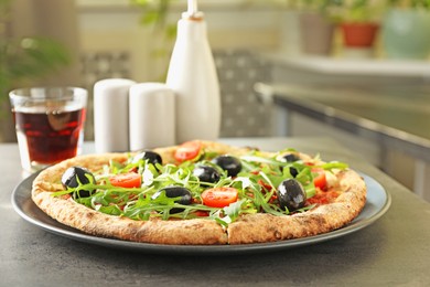 Photo of Delicious pizza with olives, cherry tomatoes, arugula and soda drink on grey table indoors, closeup