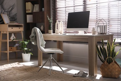 Photo of Comfortable workplace with computer in home office