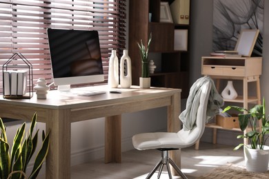 Photo of Comfortable workplace with computer in home office