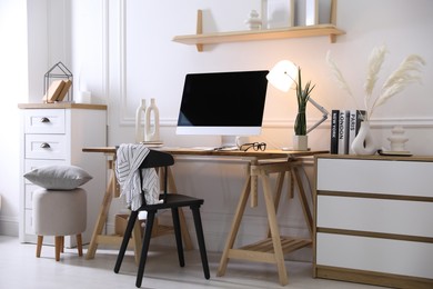 Photo of Comfortable workplace with computer in home office