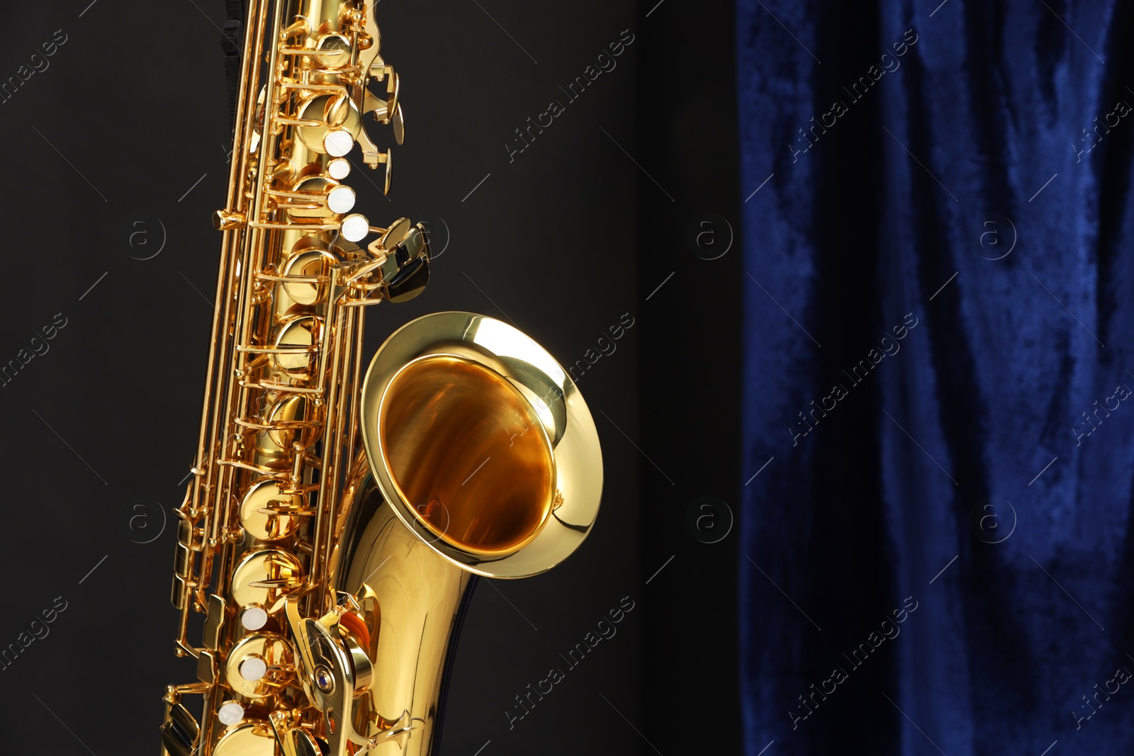 Photo of Jazz. One beautiful saxophone on color background, closeup. Space for text