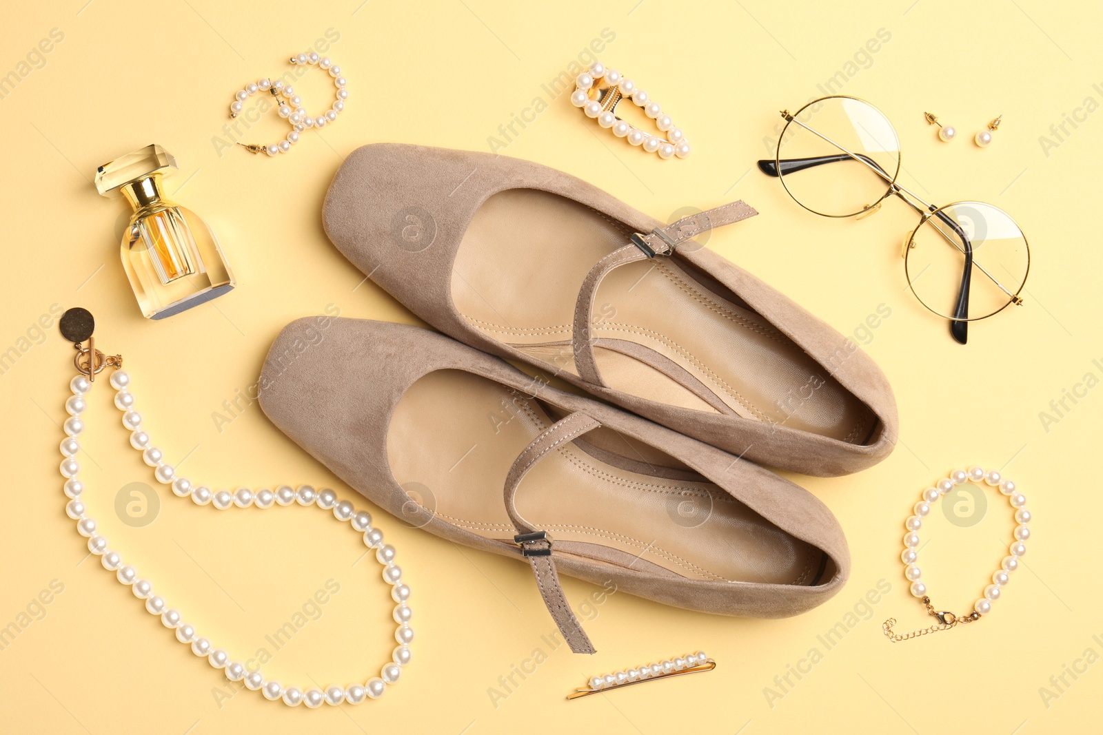 Shoes and stylish accessories on beige background, flat lay Photo of Shoes and stylish accessories on beige background, flat lay