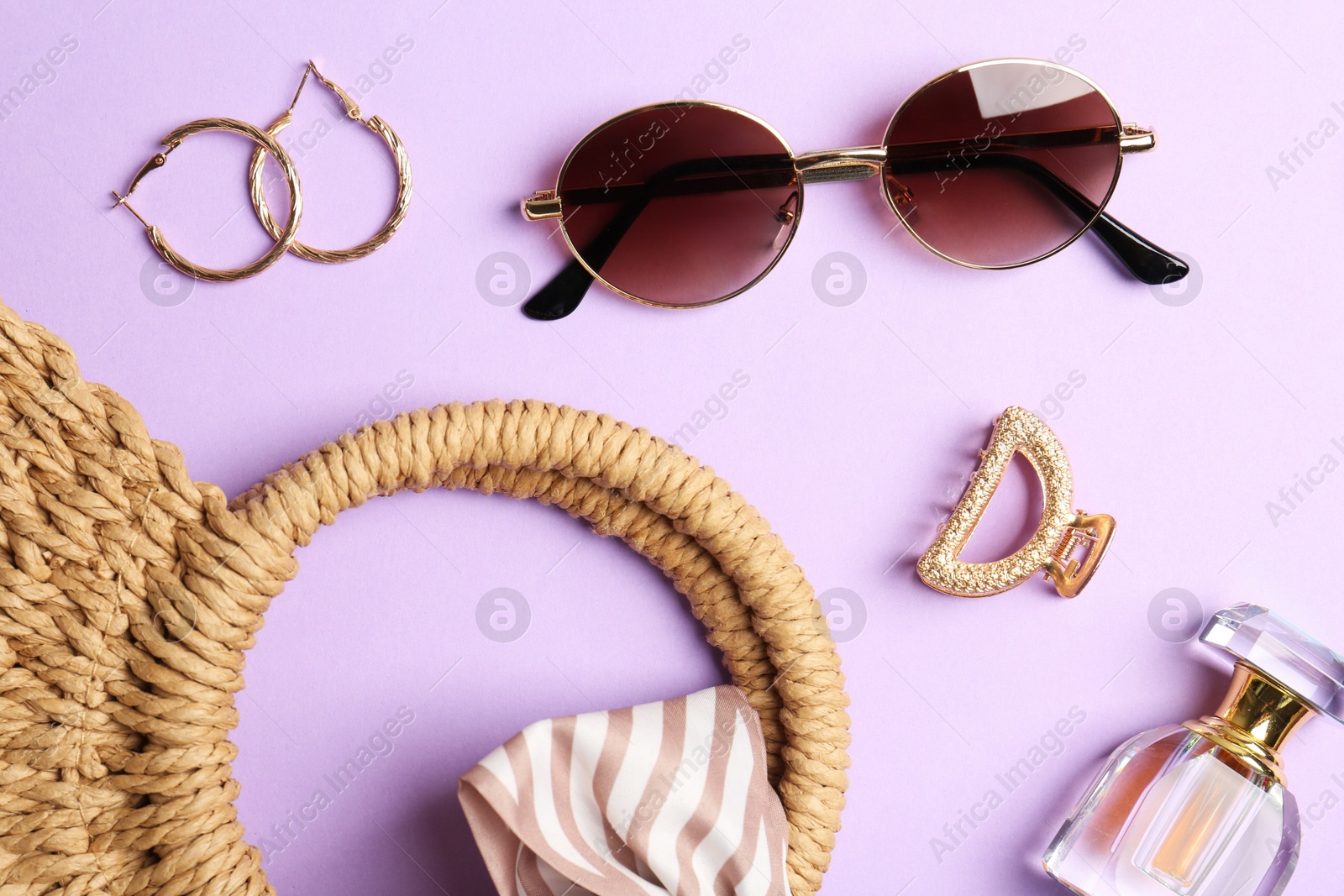 Bag and stylish accessories on lilac background, flat lay Photo of Bag and stylish accessories on lilac background, flat lay