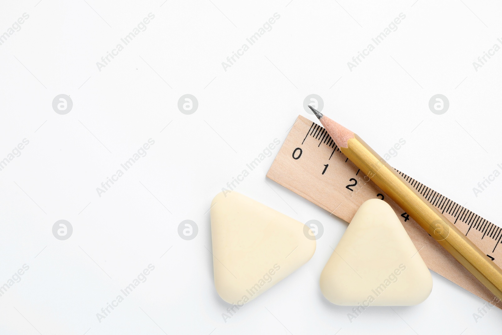 Photo of Erasers, ruler and pencil on white background, flat lay. Space for text