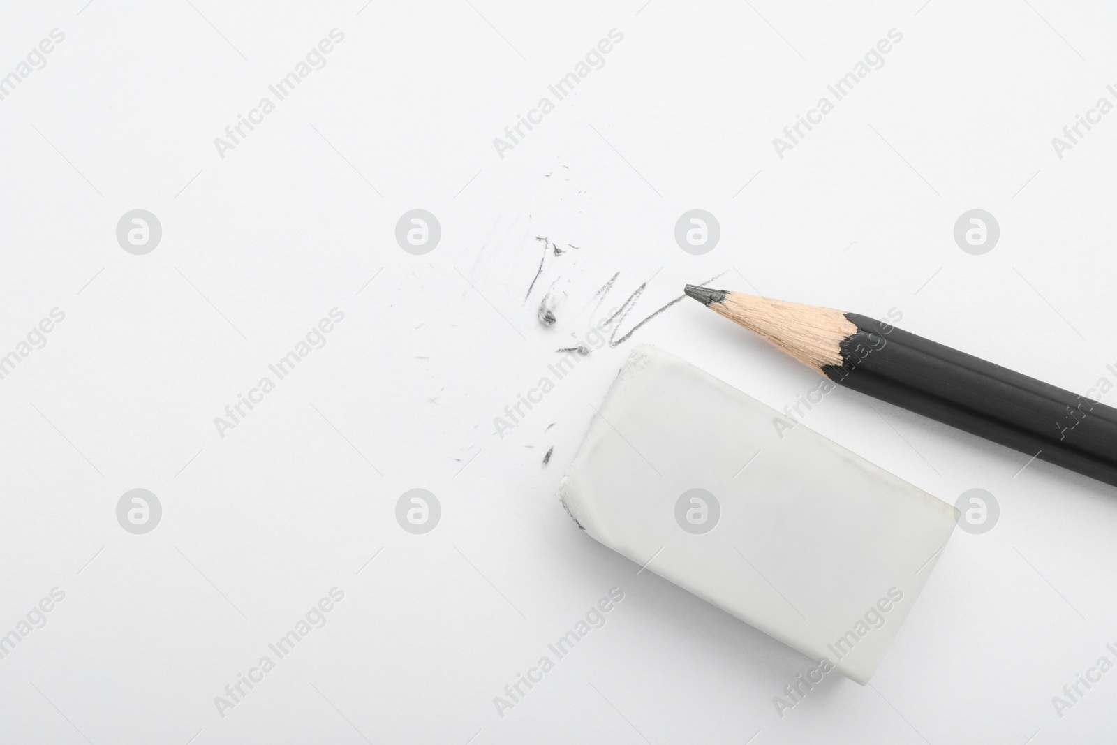 Photo of Eraser and pencil on white background, flat lay. Space for text