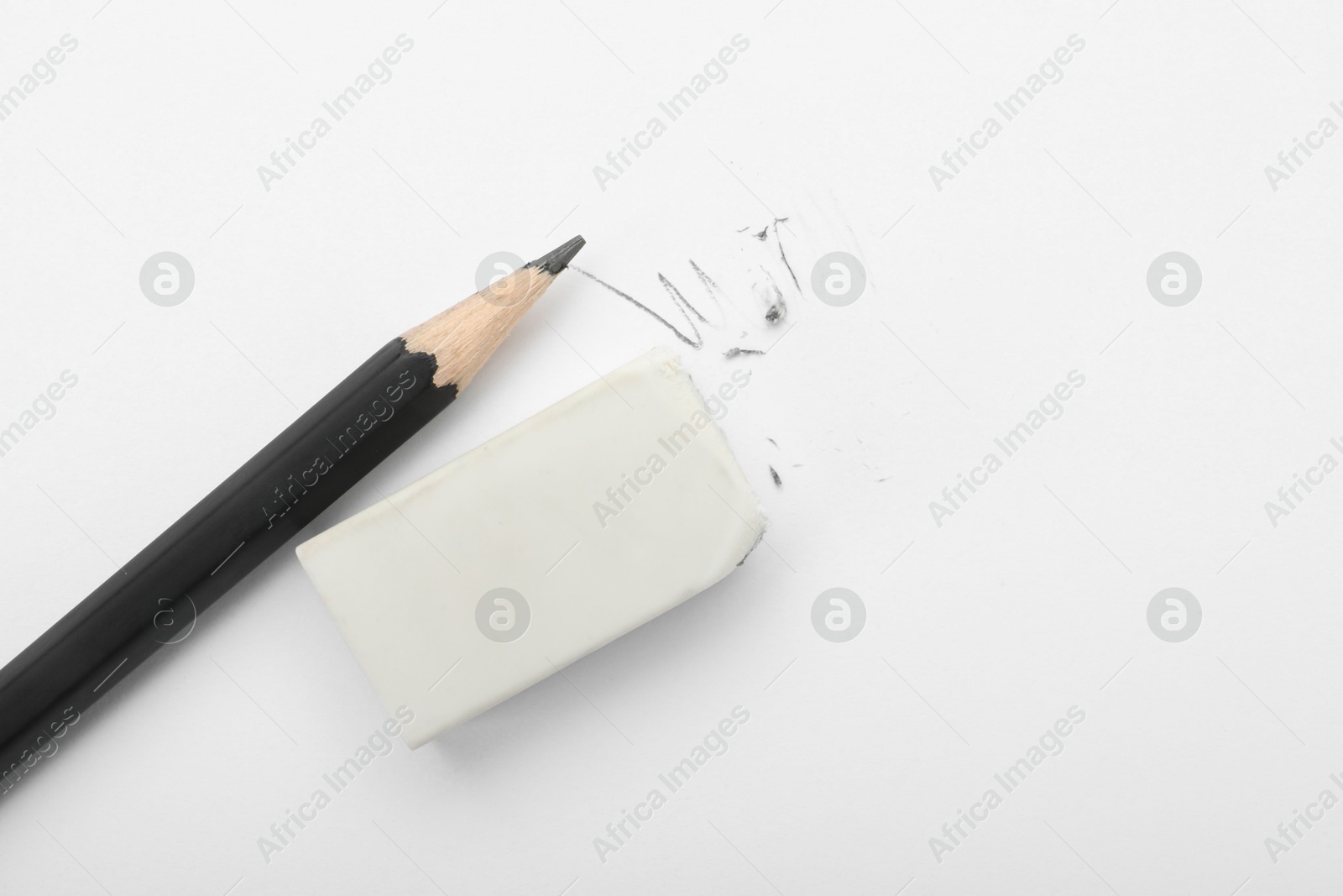 Photo of Eraser and pencil on white background, flat lay. Space for text