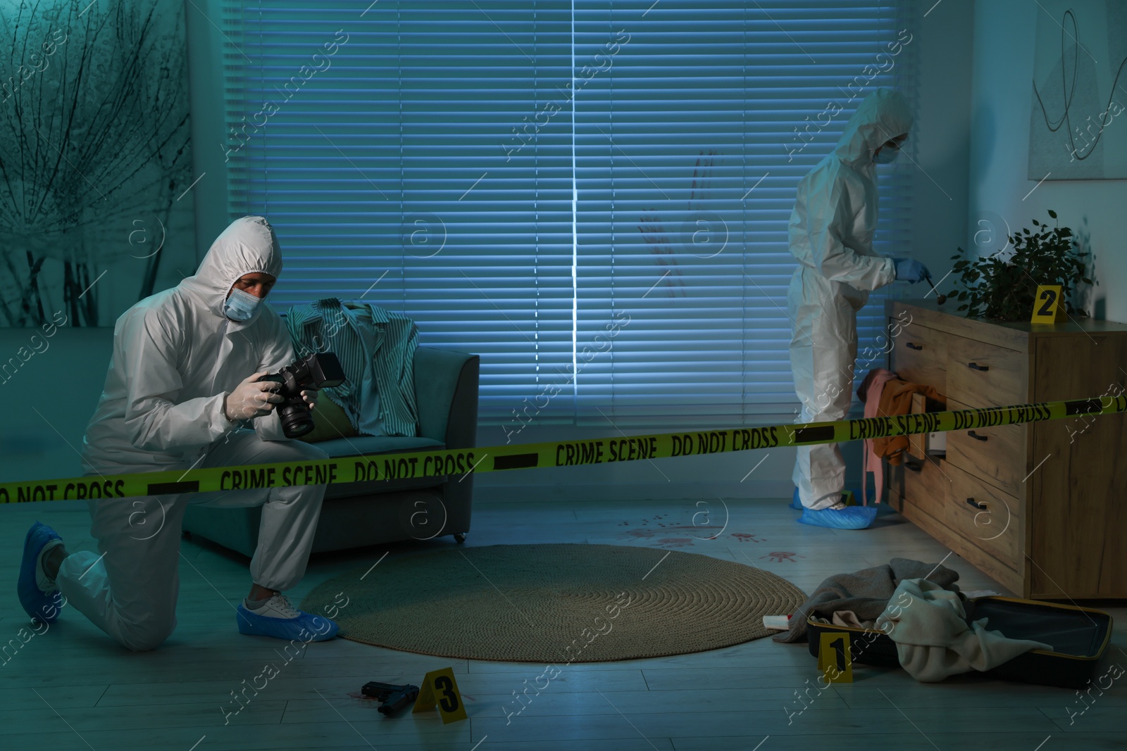 Photo of Forensic experts working at crime scene indoors