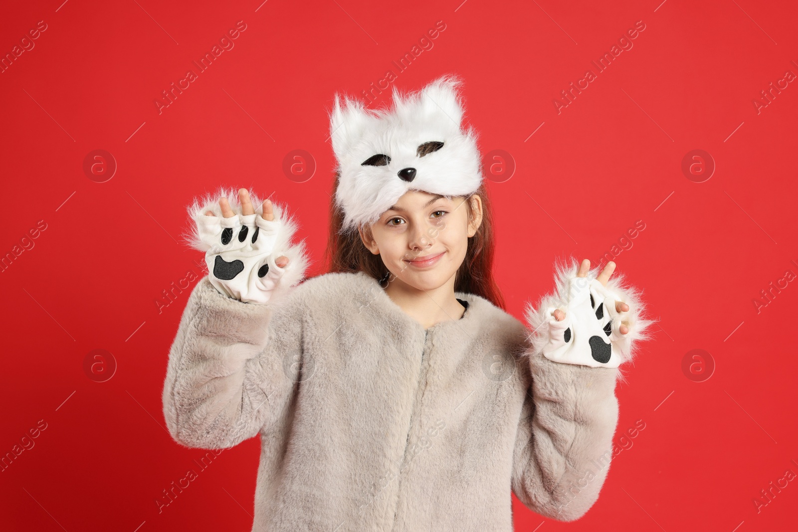 Photo of Quadrobics. Girl wearing cat mask and gloves on red background