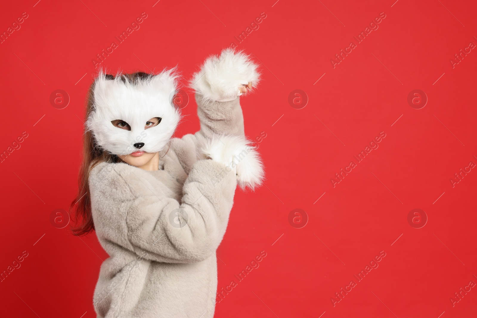 Photo of Quadrobics. Girl wearing cat mask and gloves on red background, space for text