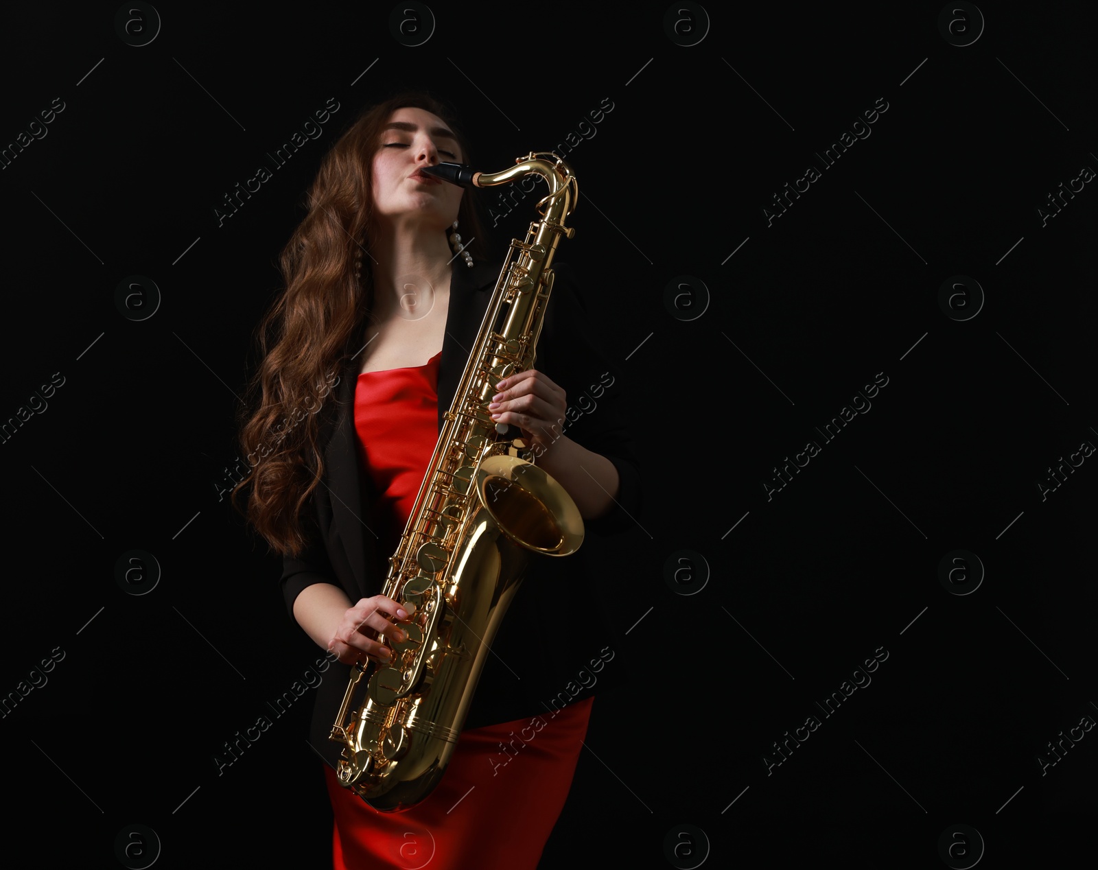 Photo of Professional musician playing saxophone on black background. Space for text