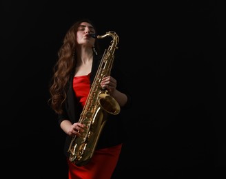 Professional musician playing saxophone on black background. Space for text