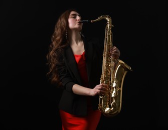 Photo of Professional musician playing saxophone on black background