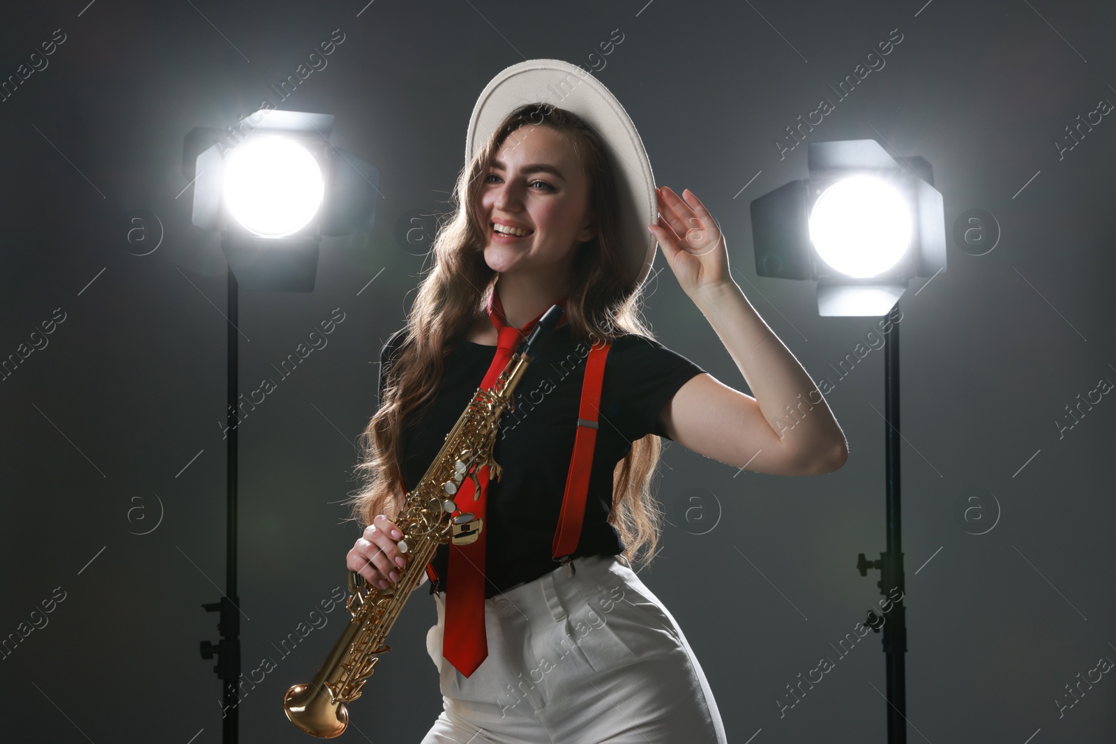 Photo of Musician with soprano saxophone on grey background