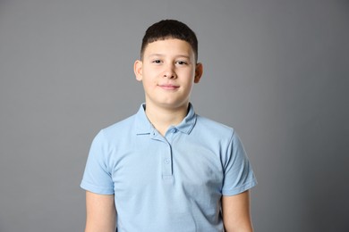 Photo of Portrait of teenage boy on grey background