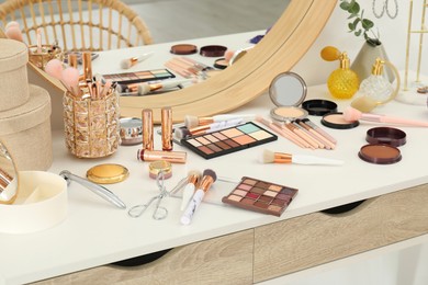 Makeup room. Dressing table with mirror and different beauty products indoors