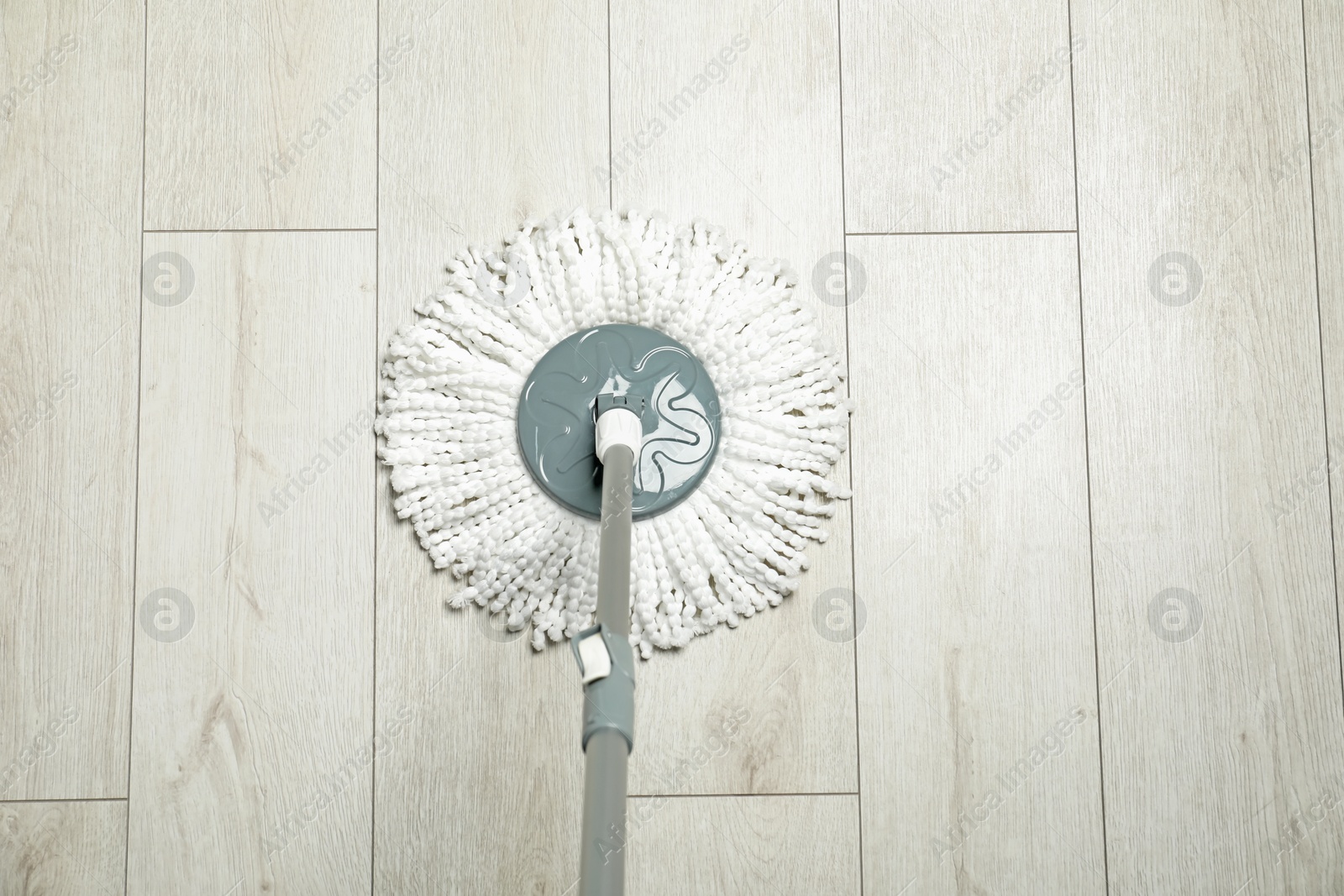 Photo of String mop on wooden floor, above view